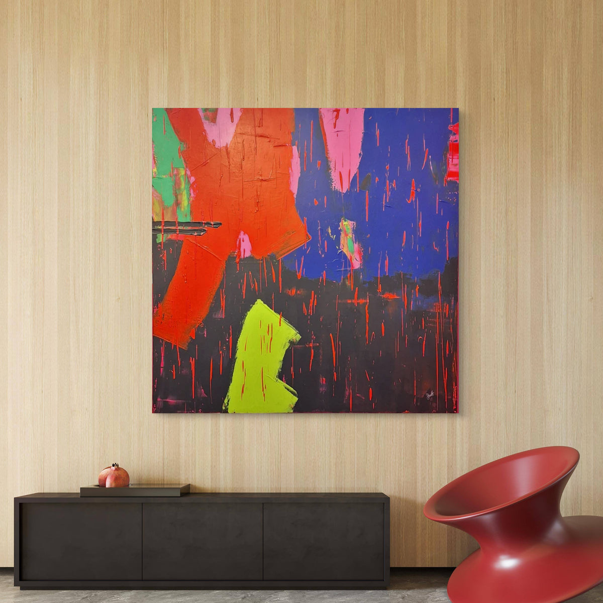 Abstract painting with vibrant colors on a wall above a black console table and red chair. Abstract painting by irish contemporary artist Áine Hayes hanging in a modern interior home. 