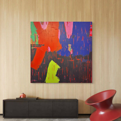 Abstract painting with vibrant colors on a wall above a black console table and red chair. Abstract painting by irish contemporary artist Áine Hayes hanging in a modern interior home. 